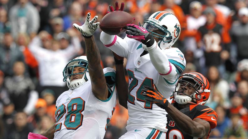 Sean Smith of the Dolphins bobbles a pass intended for A.J. Green of the Bengals.