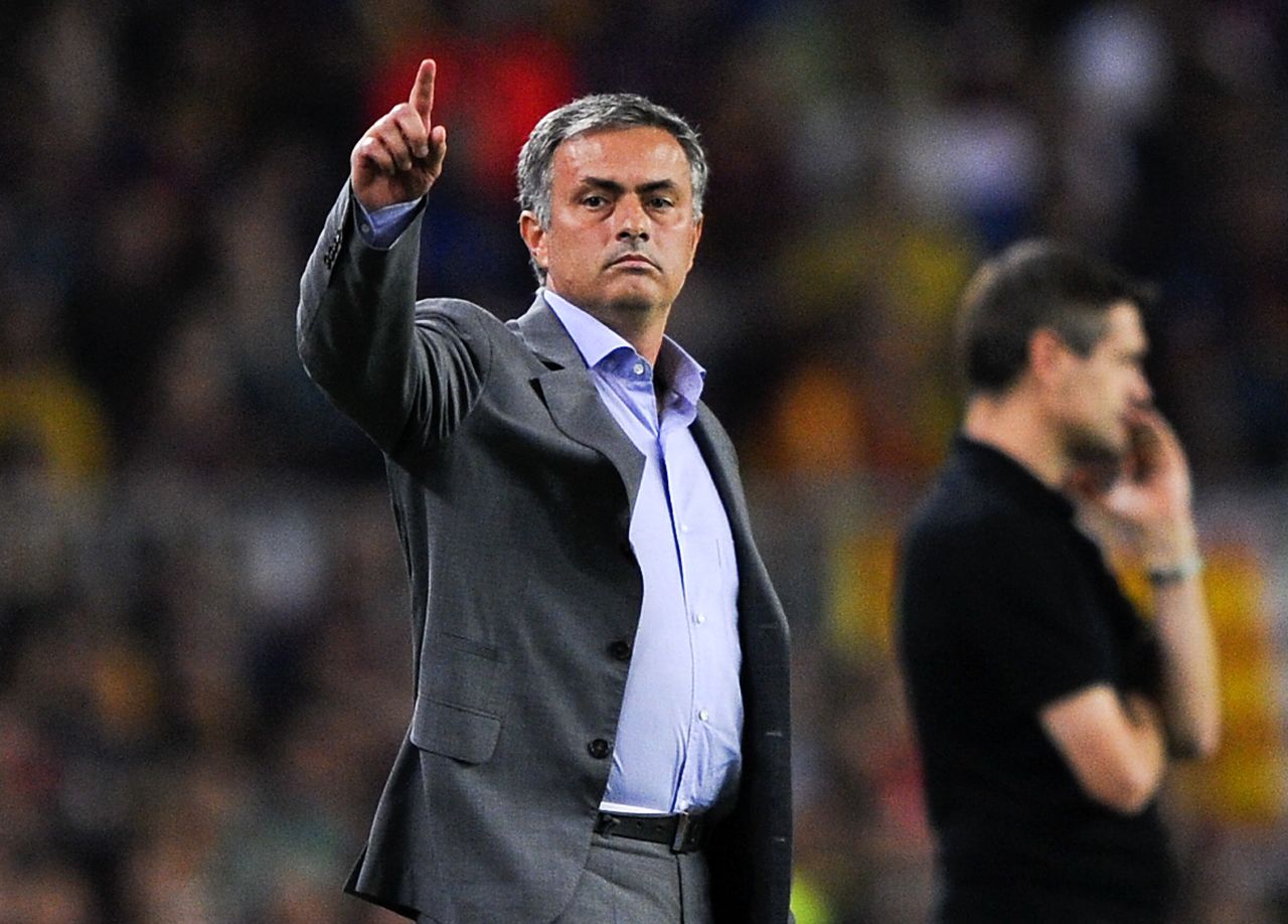 Jose Mourinho gestures during the El Clasico clash with his Barcelona counterpart Tito Vilanova in the background.  