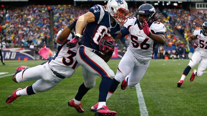 Wes Welker of the New England Patriots runs the ball on a punt return against the Denver Broncos.