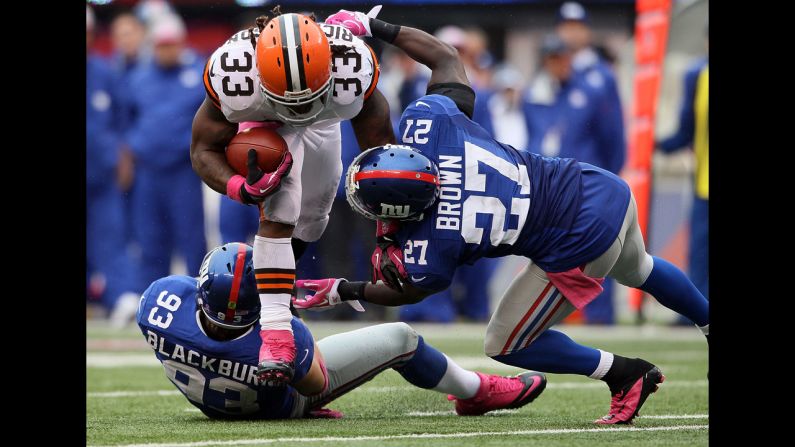 Chase Blackburn and Stevie Brown of the New York Giants tackle Trent Richardson of the Cleveland Browns on Sunday at MetLife Stadium in East Rutherford, New Jersey.