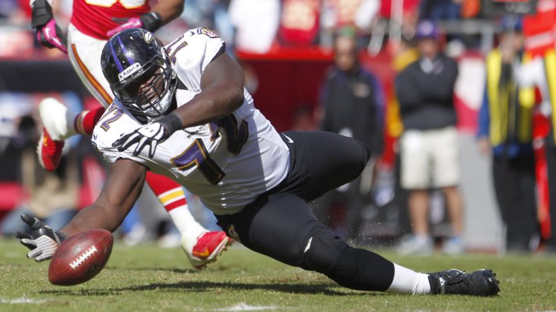 Kelechi Osemele of the Baltimore Ravens attempts to recover a fumble before the Kansas City Chiefs late in the fourth quarter Sunday at Arrowhead Stadium in Kansas City, Missouri.