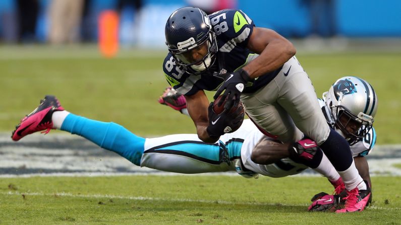 Sherrod Martin of the Panthers tackles Doug Baldwin of the Seahawks.