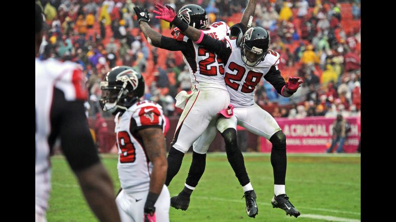 No. 25 William Moore and No. 28 Thomas DeCoud of the Atlanta Falcons celebrate after an interception late in the fourth quarter.