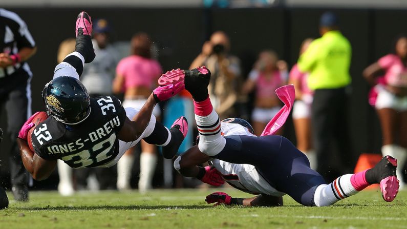 Maurice Jones-Drew of the Jacksonville Jaguars gets tripped up by  Major Wright of the Chicago Bears.