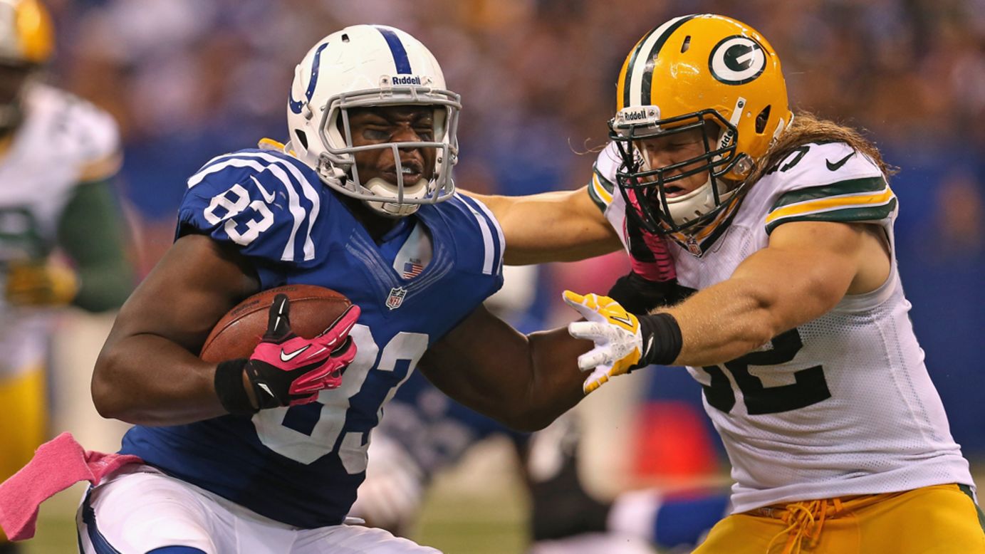 Clay Matthews of the Green Bay Packers tackles Dwayne Allen of the Indianapolis Colts on Sunday at Lucas Oil Stadium in Indianapolis.
