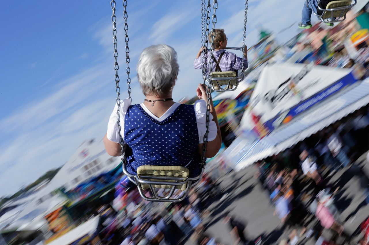 People dressed in traditional Bavarian clothing ride swings during Friday's festivities.