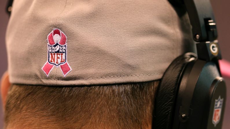 Green Bay Packers head coach Mike McCarthy wears a hat with a breast cancer awareness symbol on Sunday.