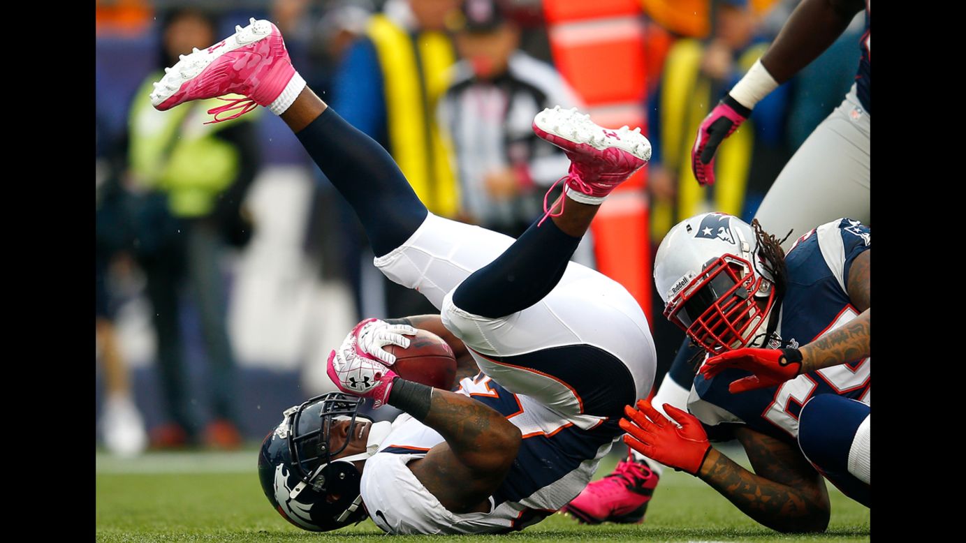 Willis McGahee of the Denver Broncos is stopped by Brandon Spikes of the New England Patriots.