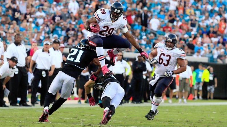 Michael Bush of the Chicago Bears jumps over Chris Prosinski of the Jacksonville Jaguars.