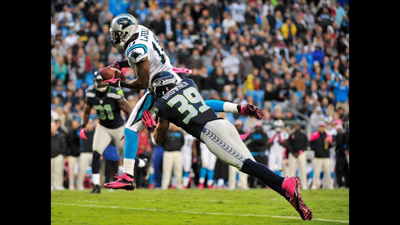 Brandon LaFell of the Carolina Panthers makes a leaping first-down catch against defender Brandon Browner of the Seattle Seahawks.