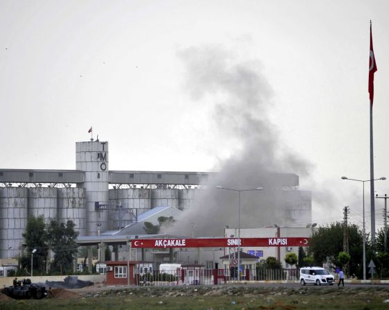 Smoke rises at a border gate in  Akcakale, Turkey, near the Syrian border on Sunday, October 7, after a shell fired from Syria. Turkey fired on Syrian government targets in response. No was injured in Sunday's shelling, a witness said. Akcakale is the same town where five Turks were killed last week in another cross-border incident. <a href="index.php?page=&url=http%3A%2F%2Fwww.cnn.com%2F2012%2F07%2F16%2Fmiddleeast%2Fgallery%2Fsyria-unrest%2Findex.html" target="_blank">See photos of Syria's internal violence.</a>