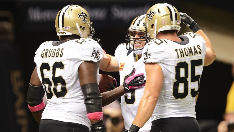 Brees celebrates setting an NFL reocrd with his teammates Sunday.