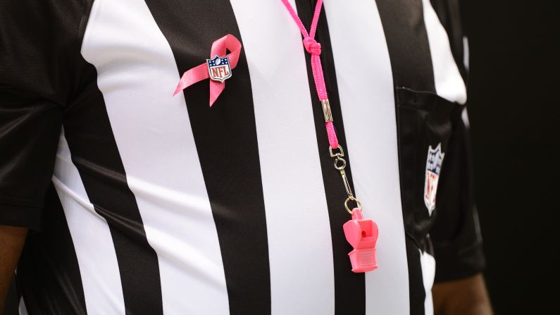 An official wears a pink ribbon and whistle for Sunday's game between the Chargers and the Saints. October is National Breast Cancer Awareness Month.