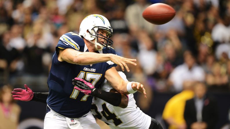 Corey White of the Saints hits Chargers quarterback Philip Rivers as he throws a pass in the first quarter.