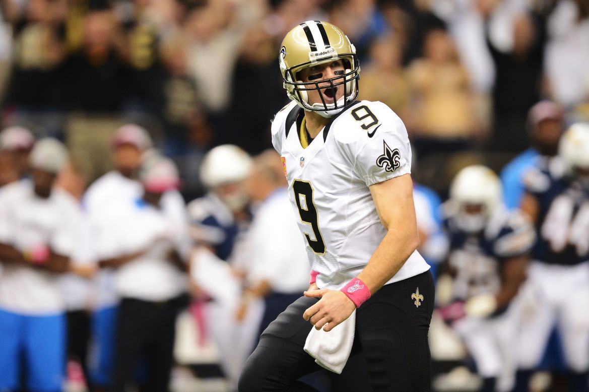 Brees celebrates his record-breaking touchdown pass in the first quarter against the Chargers on Sunday. The Saints quarterback threw a touchdown pass in his 48th consecutive NFL game, breaking the mark set by Johnny Unitas a half-century ago.