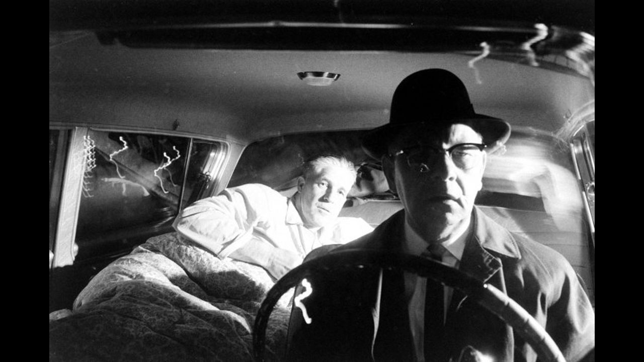 George Romney gets ready to sleep in the back of his car as a chauffeur drives home to Bloomfield Hills, Michigan, after a long day of work on a new state constitution and a quick change into pajamas in 1962. Mitt Romney's father was elected governor of Michigan that year.