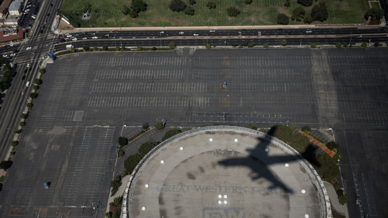 Air Force One leaves a shadow as it passes over the Forum on approach to Los Angeles International Airport on Sunday.