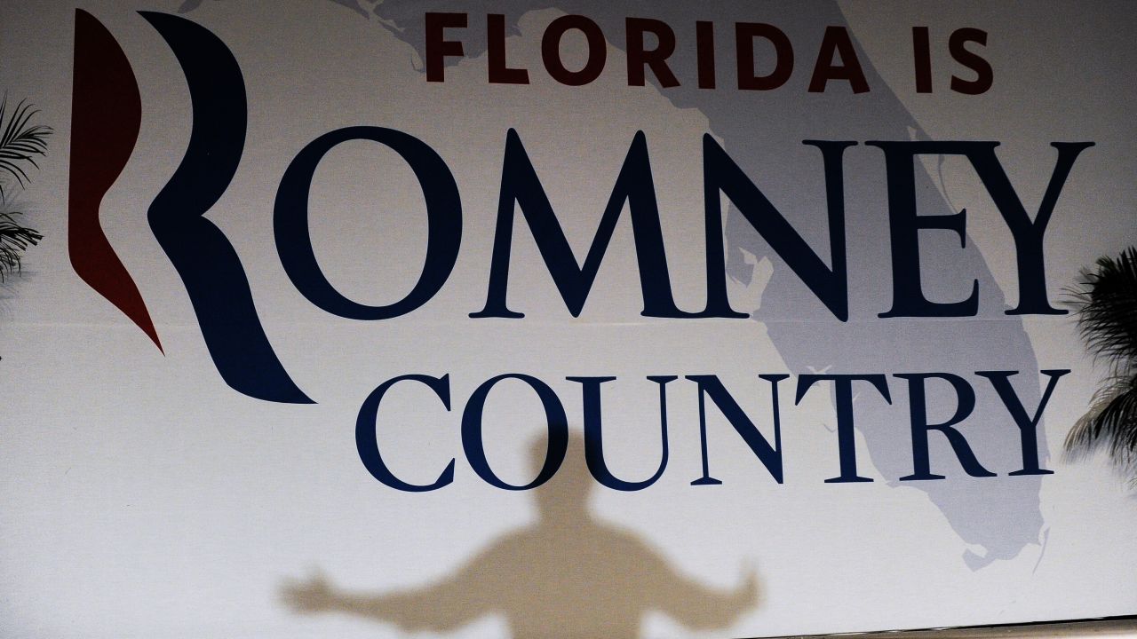Romney casts a shadow on a banner as he speaks during a campaign event in Apopka, Florida, on Saturday, October 6.