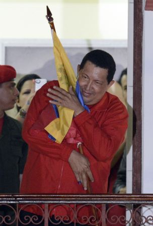 Hugo Chavez embraces a Venezuelan flag after winning re-election Sunday, October 7. Chavez, who has been Venezuela's president since 1999, defeated Henrique Capriles Radonski. <a href="index.php?page=&url=http%3A%2F%2Fwww.cnn.com%2FSPECIALS%2Fworld%2Fphotography%2Findex.html" target="_blank">See more of CNN's best photography</a>.