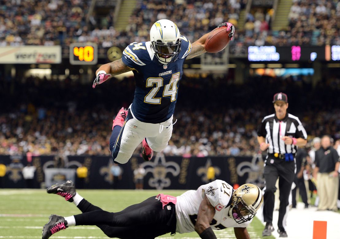 Ryan Mathews of the San Diego Chargers dives over Malcolm Jenkins of the New Orleans Saints to score a touchdown and take a 24-14 lead during the third quarter on Sunday, October 7, at the Mercedes-Benz Superdome in New Orleans.
