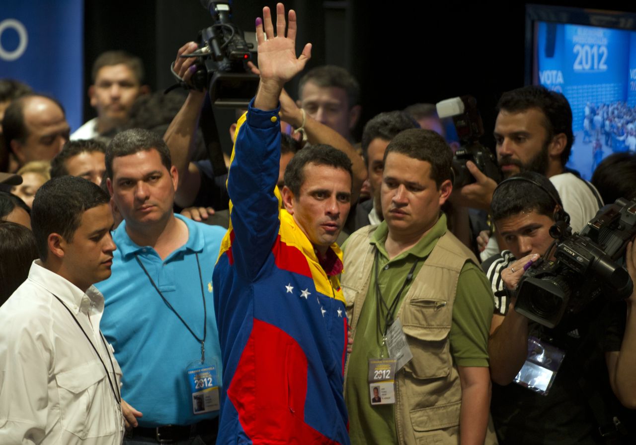Opposition candidate Henrique Capriles Radonski waves to supporters Sunday night in Caracas after learning of his defeat. During the campaign, he criticized the Chavez administration for inefficiencies, infrastructure shortcomings and corruption.