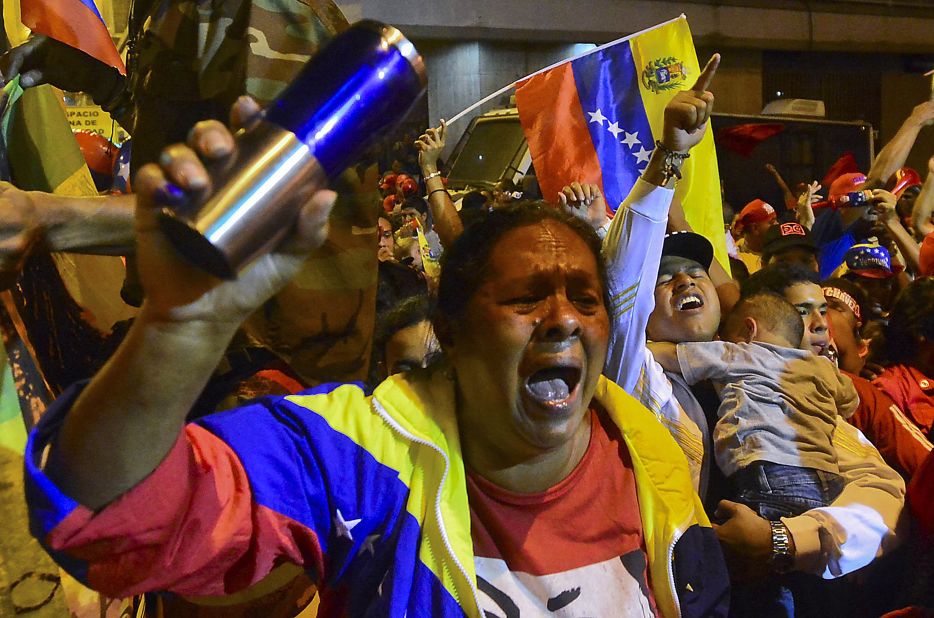 Chavez backers cheer Sunday night as provisional returns show the president won a new six-year term.