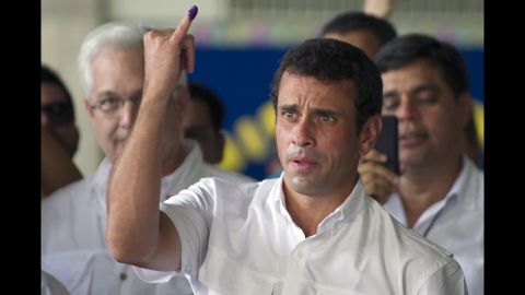 Opposition candidate Henrique Capriles Radonski shows his finger after voting Sunday in Caracas. With 90% of the ballots counted Sunday night, Chavez won 54.42% of the vote, compared with 44.97% for Capriles, according a National Electoral Council official.