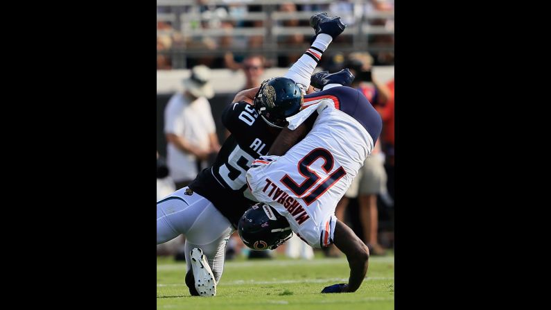 Russell Allen of the Jaguars tackles Brandon Marshall of the Bears on Sunday.