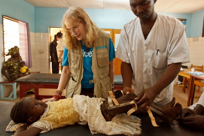 UNICEF Goodwill Ambassador Mia Farrow chats with seven-year-old Massi Hassan, whose leg brace is being adjusted by a health worker, at the Notre-Dame de Paix rehabilitation centre in the town of Moundou in southwestern Chad.