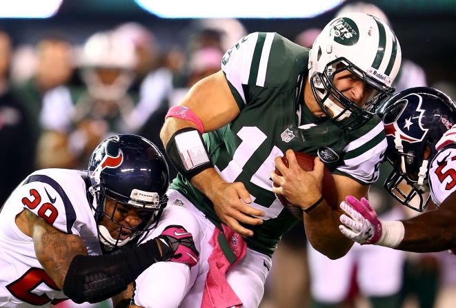 Backup quarterback Tim Tebow of the Jets is tackled after running the ball against the Texans on Monday.