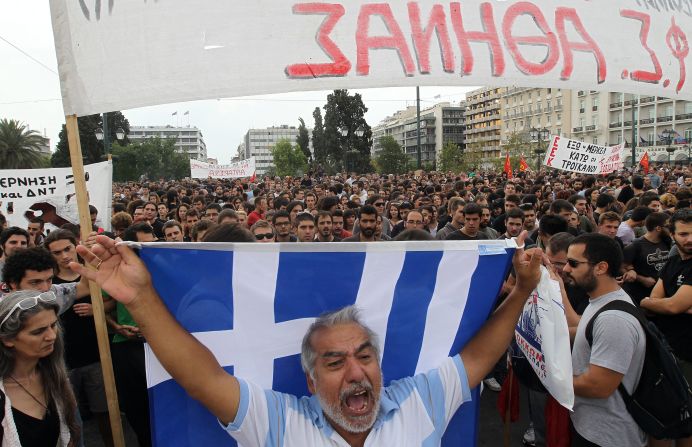 Protesters shout in front of the Parliament building.