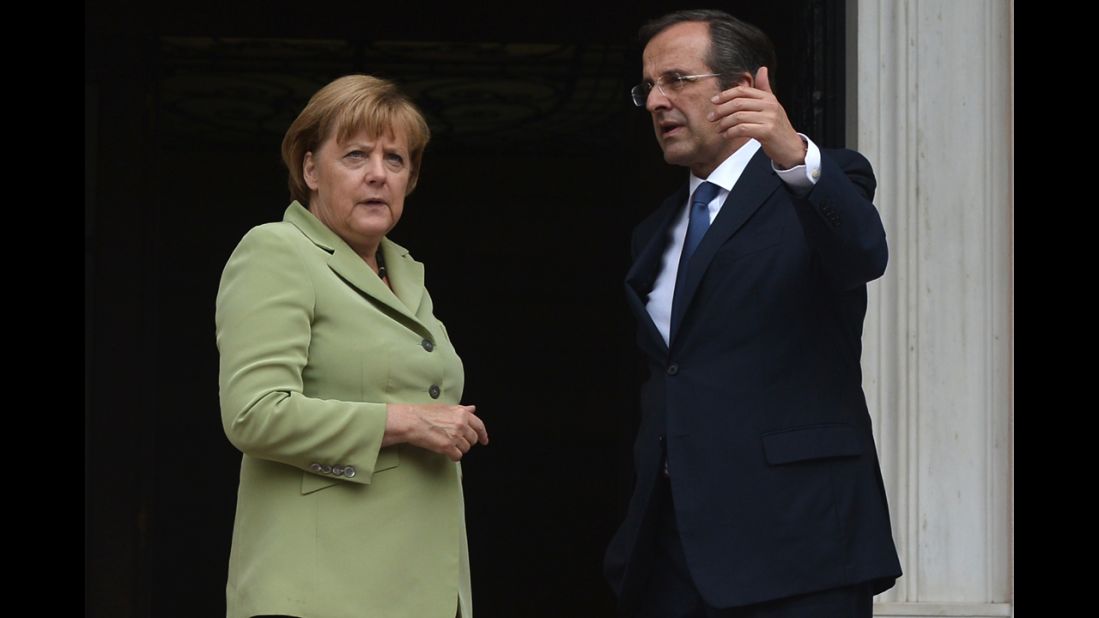 Greek Prime Minister Antonis Samaras welcomes German Chancellor Angela Merkel before their meeting in Athens.
