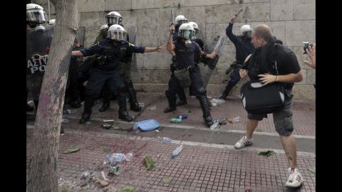 Demonstrators clash with riot police protecting the Greek parliament.