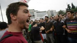 Demonstrators shout slogans protesting Angela Merkel's visit to Greece on October 9, 2012 in Athens