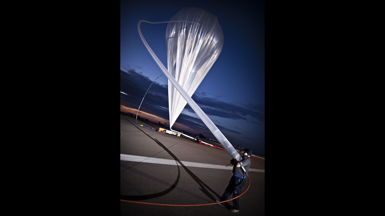 ATA crew members fill the balloon with helium at the flight line on July 25.