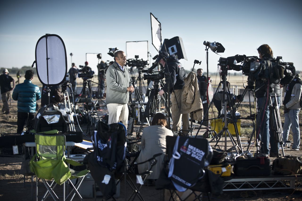TV crews report from the launch site.