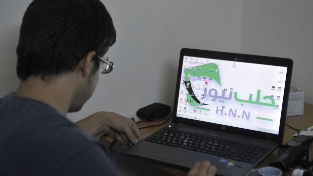 Abu Mahmud, a 20-year-old technician, looks at a laptop in the Syrian city of Aleppo on October 7, 2012.