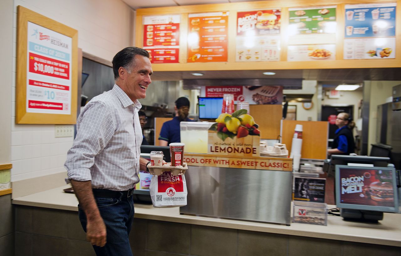 Republican presidential candidate Mitt Romney departs a Wendy's restaurant with his dinner order in Cuyahoga Falls, Ohio, on Tuesday.