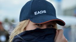A woman wears the logo of European aerospace giants EADS on her hat in Schoenefeld near Berlin on September 13, 2012.