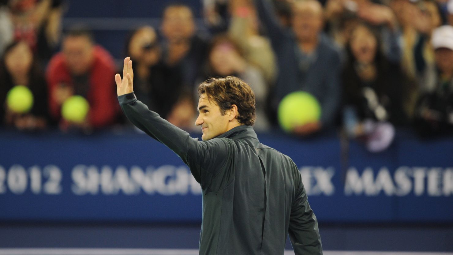 Roger Federer waves to the crowd in Shanghai after his victory over fellow Swiss Stanislas Wawrinka