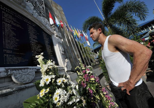 Survivor Phil Britten looks at the names of dead victims at a memorial monument three days before a ceremony to remember those killed. He was just 22 years old and had only been in Bali a few hours when he was caught in the blast and suffered burns to 60% of his body.