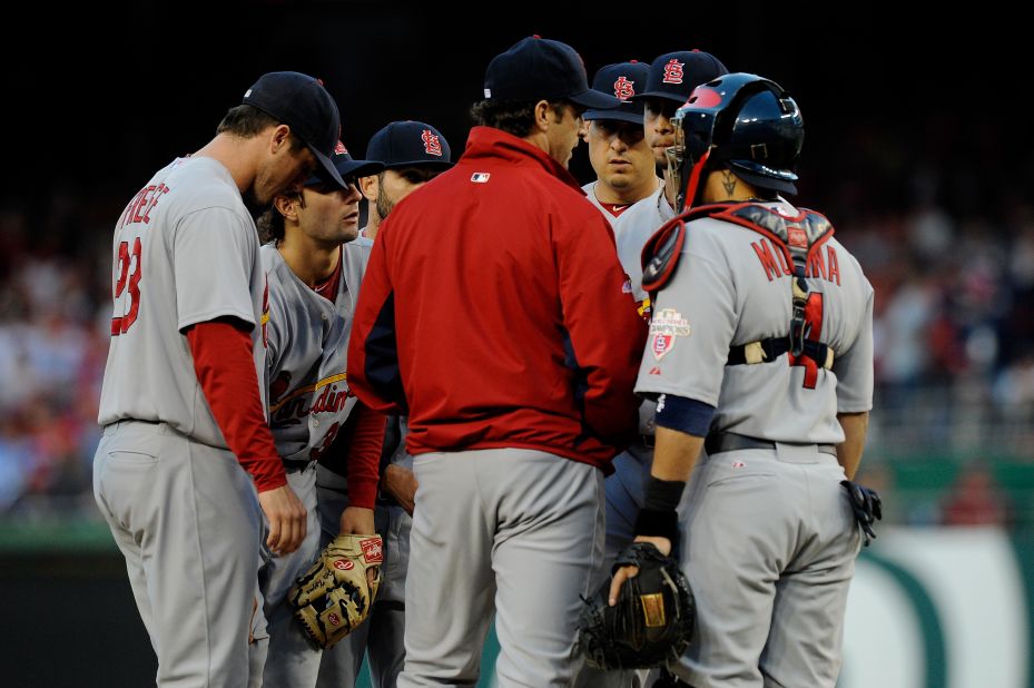 Cardinals Manager Mike Matheny talks with starting pitcher Kyle Lohse and other players on the mound during Thursday's Game 4 of the National League Division Series in Washington.