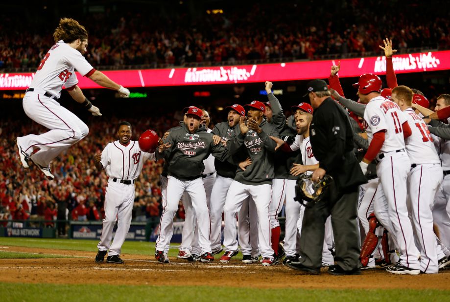 Jayson Werth is met by his Washington Nationals teammates as he jumps on home plate after his game-winning solo home run in the bottom of the ninth inning Thursday against the St. Louis Cardinals in Game 4 of the National League Division Series at Nationals Park.