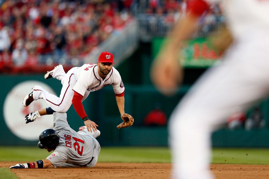 Allen Craig of the St. Louis Cardinals slides safely into second base as Danny Espinosa of the Washington Nationals throws to first to retire the Cards' Yadier Molina in the top of the sixth inning in Washington. 