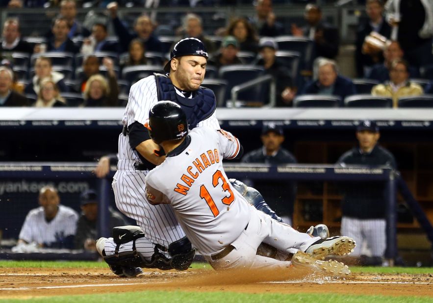 Yankees catcher Russell Martin tags Baltimore's Manny Machado out at the plate on a fielder's choice in the third inning Thursday.