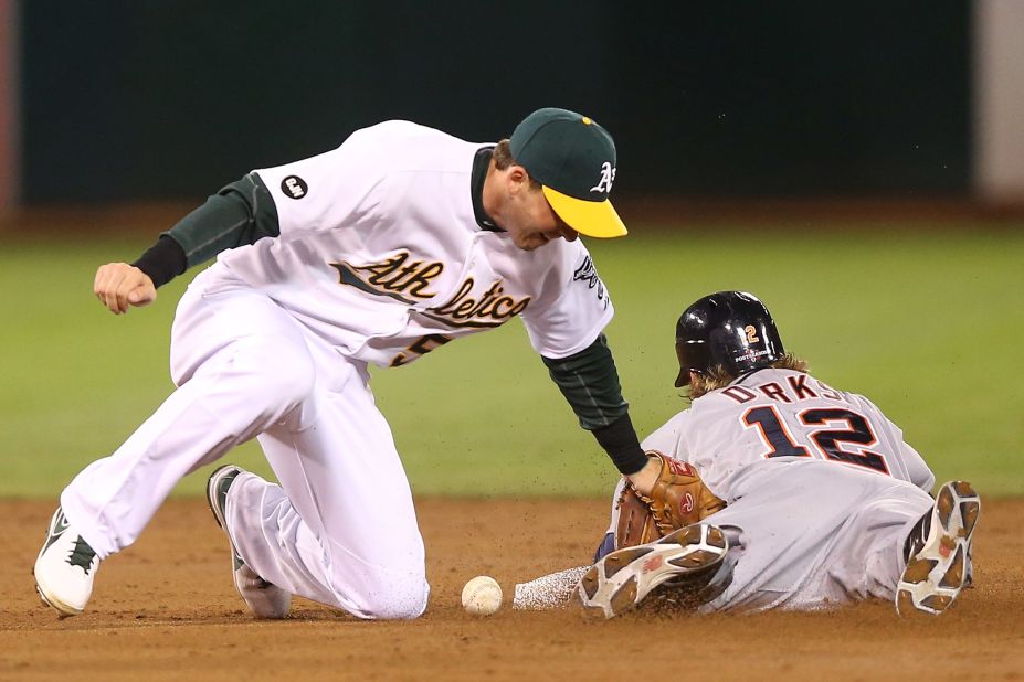 Detroit's Andy Dirks steals second base as Oakland's Stephen Drew is unable to apply the tag in the second inning Thursday night in Oakland.