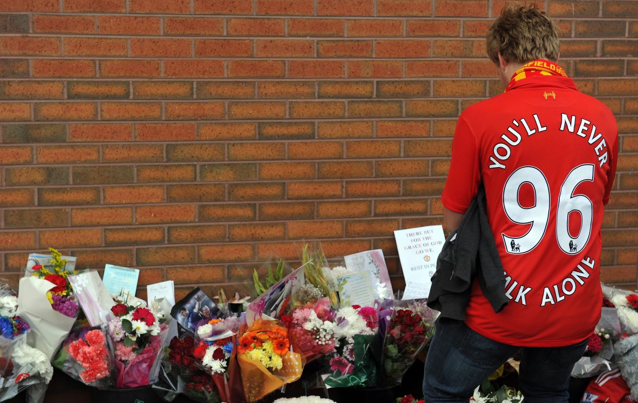 A Liverpool supporter pays his respects outside Anfield in September 2012, weeks before Britain's police watchdog said it would launch the biggest-ever independent inquiry into potential police wrongdoing after a damning report on the disaster.
