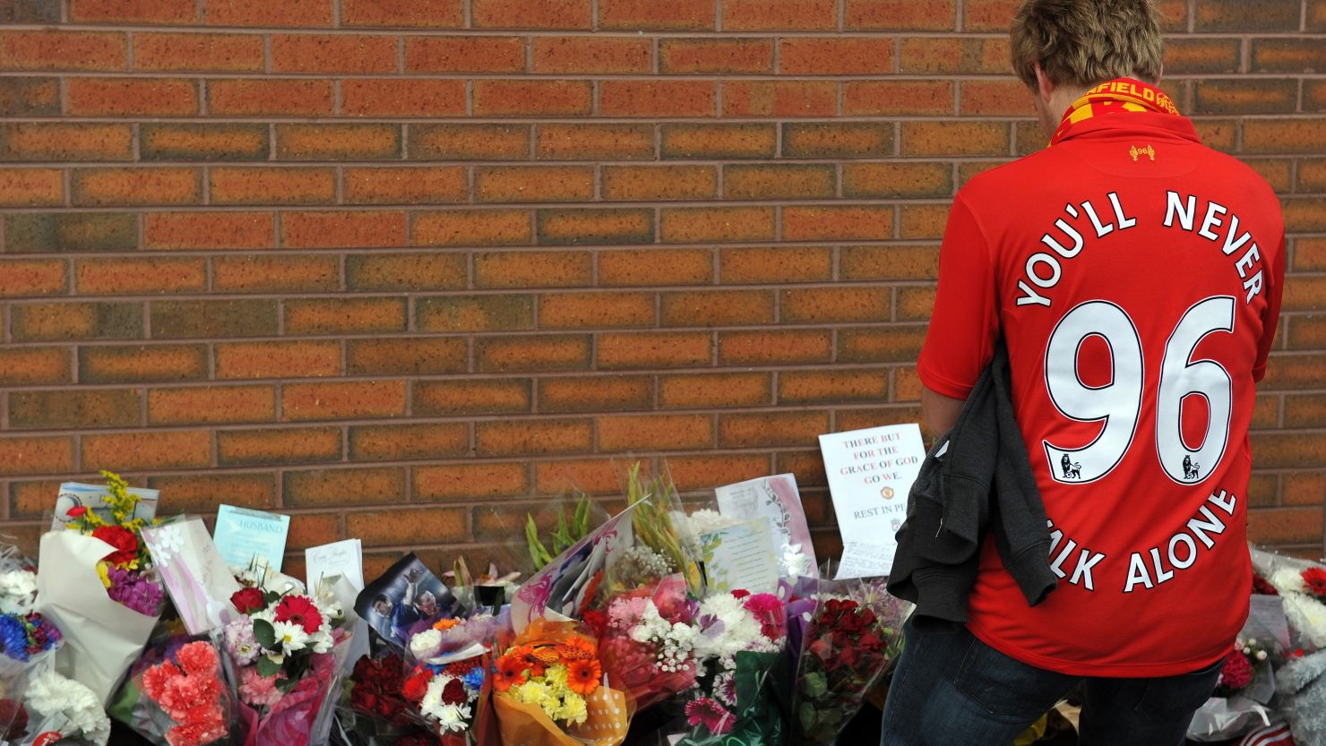 A supporter pays his respects outside Anfield on September 23 to those who died in the 1989 Hillsborough disaster.
