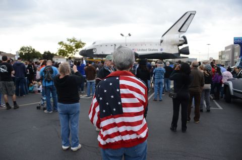 Spectators come to watch the space shuttle Endeavour as it rests at Westchester Square during its final ground journey in Los Angeles on Friday.