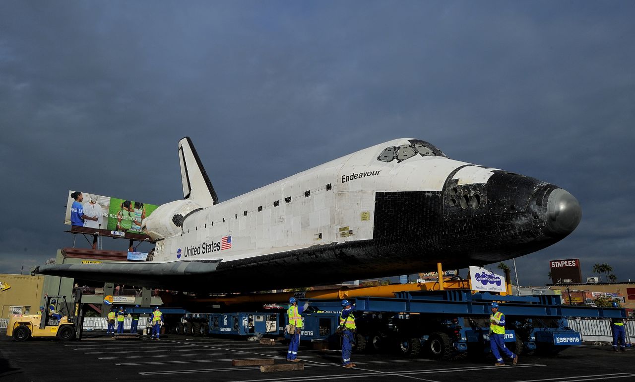 Workers check the space shuttle Endeavour as it rests at Westchester Square on Friday.